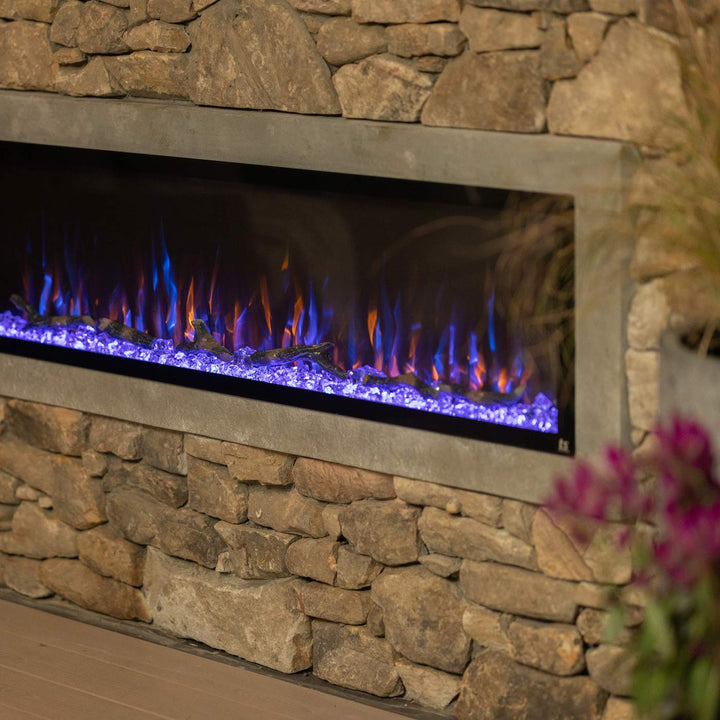 Touchstone Sideline Elite 60" Outdoor Weatherproof Smart WiFi Enabled Electric Fireplace -80049- Side View Brick Wall With Blue and Orange Flames
